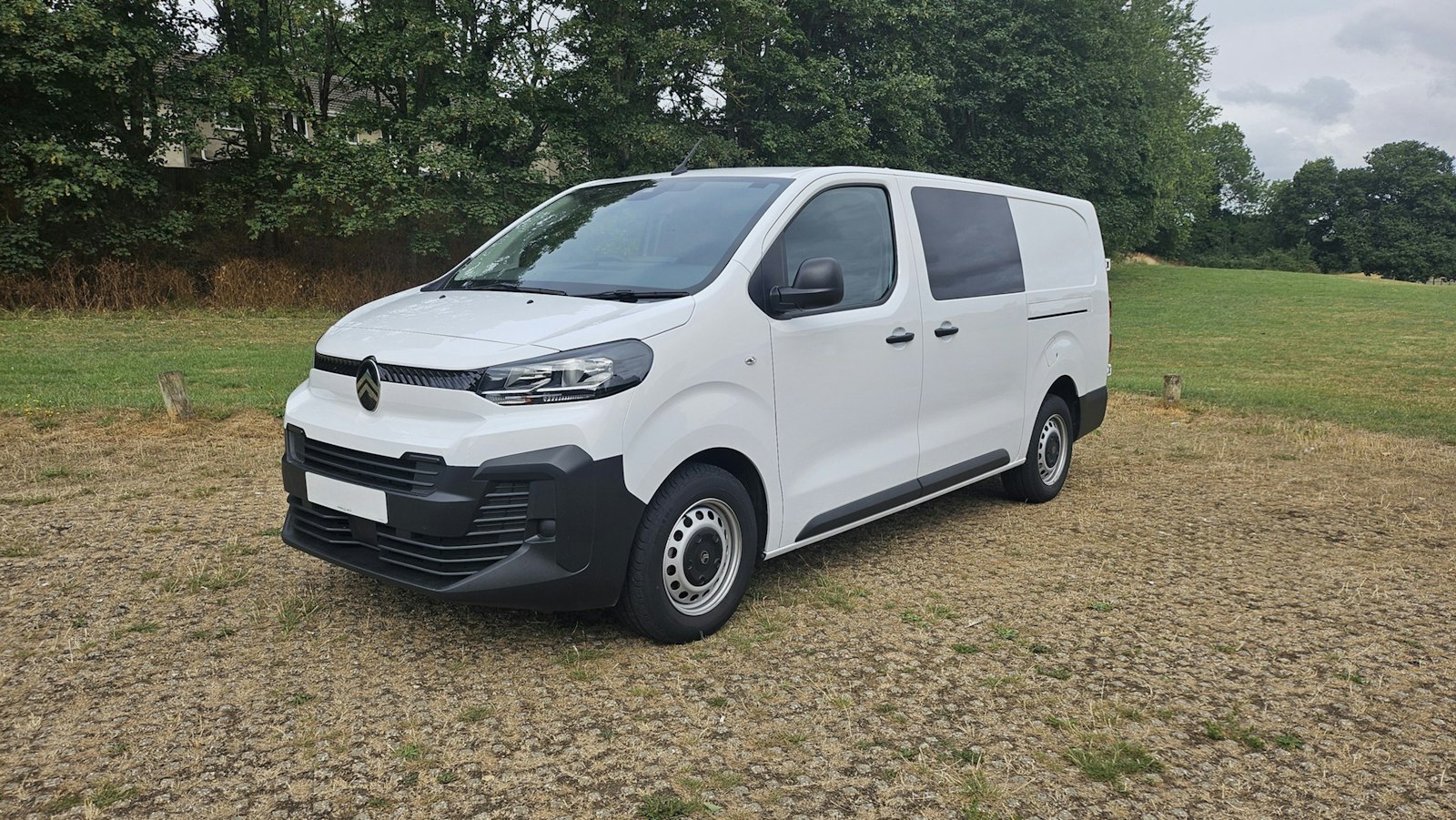 A white Summit Air service van parked on a gravel lot